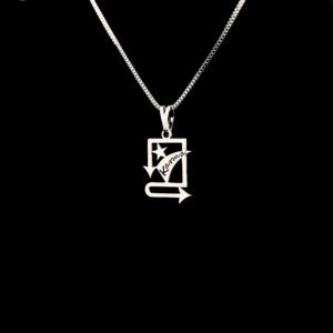 A centered product image of the Karma pendant with a box chain, set on a solid black background with the Just Pendant logo at the top-left and "KARMA" written at the bottom.