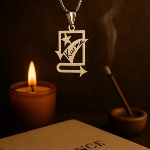 The Karma pendant suspended in air with a warm background featuring a lit candle, incense stick, and a book titled 