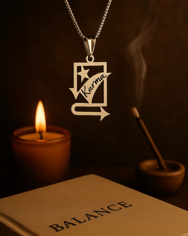 The Karma pendant suspended in air with a warm background featuring a lit candle, incense stick, and a book titled "BALANCE," evoking calm and mindful energy.